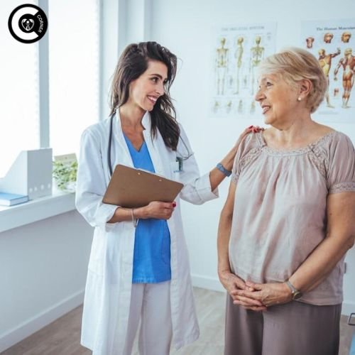 Gynecologist explaining perimenopause symptoms to attentive female patient in clinic office