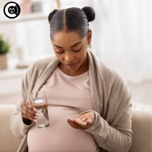 Pregnant woman holding progesterone supplement bottle with hopeful expression